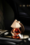 Car air freshener with wooden cap on a car dashboard